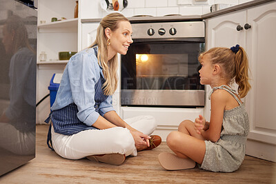 Buy stock photo Cooking, mom and child on kitchen floor in house talk and relax while waiting for food in the oven. Canada mother enjoying happy food preparation leisure break with young daughter in family home.