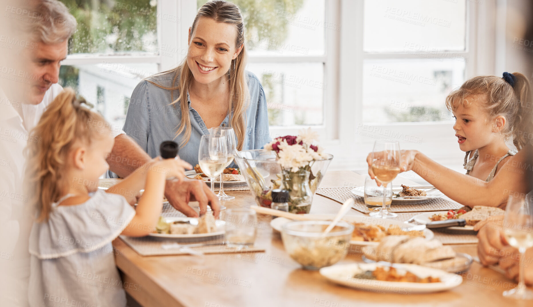 Buy stock photo Love, food and family eating at table, relaxing and sharing a meal in their family home together. Children, mother and loving grandparent bonding and talking, hungry and excited for healthy lunch