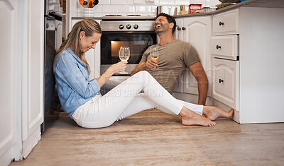 Buy stock photo Love, wine and couple in a kitchen laughing at joke while in celebration of a new home and marriage anniversary together. Romance, conversation and happy woman on house floor with a content partner