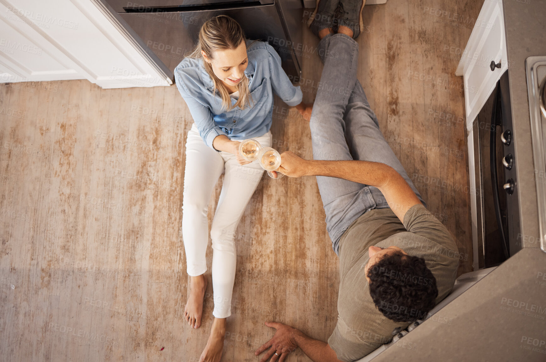 Buy stock photo Champagne, cheers and happy couple on the kitchen floor celebrating their new home renovations. Top view of happiness, sparkling wine and toast to the family house of man and woman relaxing together.