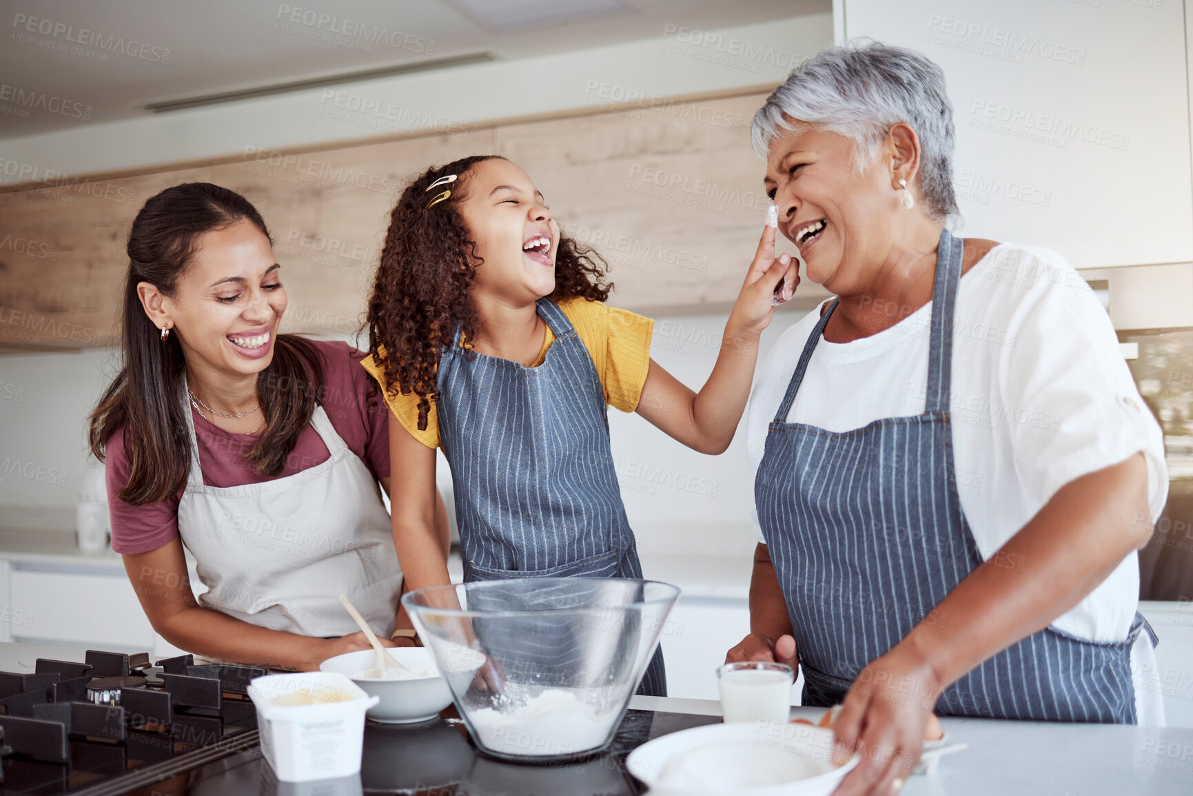 Buy stock photo Women, happy family and bake food in kitchen smile together love cooking dessert and bonding at family home. Excited, happiness and smiling elderly grandmother, mom and girl kid baking fun at house