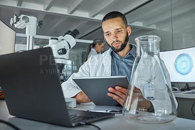 Buy stock photo Tablet, laptop and laboratory man with glass beaker in medical research, healthcare innovation study or vaccine data analysis. Thinking scientist, medicine worker or technology for future dna science