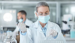 Covid, lab mask and vaccine research woman with medicine analysis test tube in a lab. Medical development, innovation and professional science expert working on new medical analytics in a laboratory