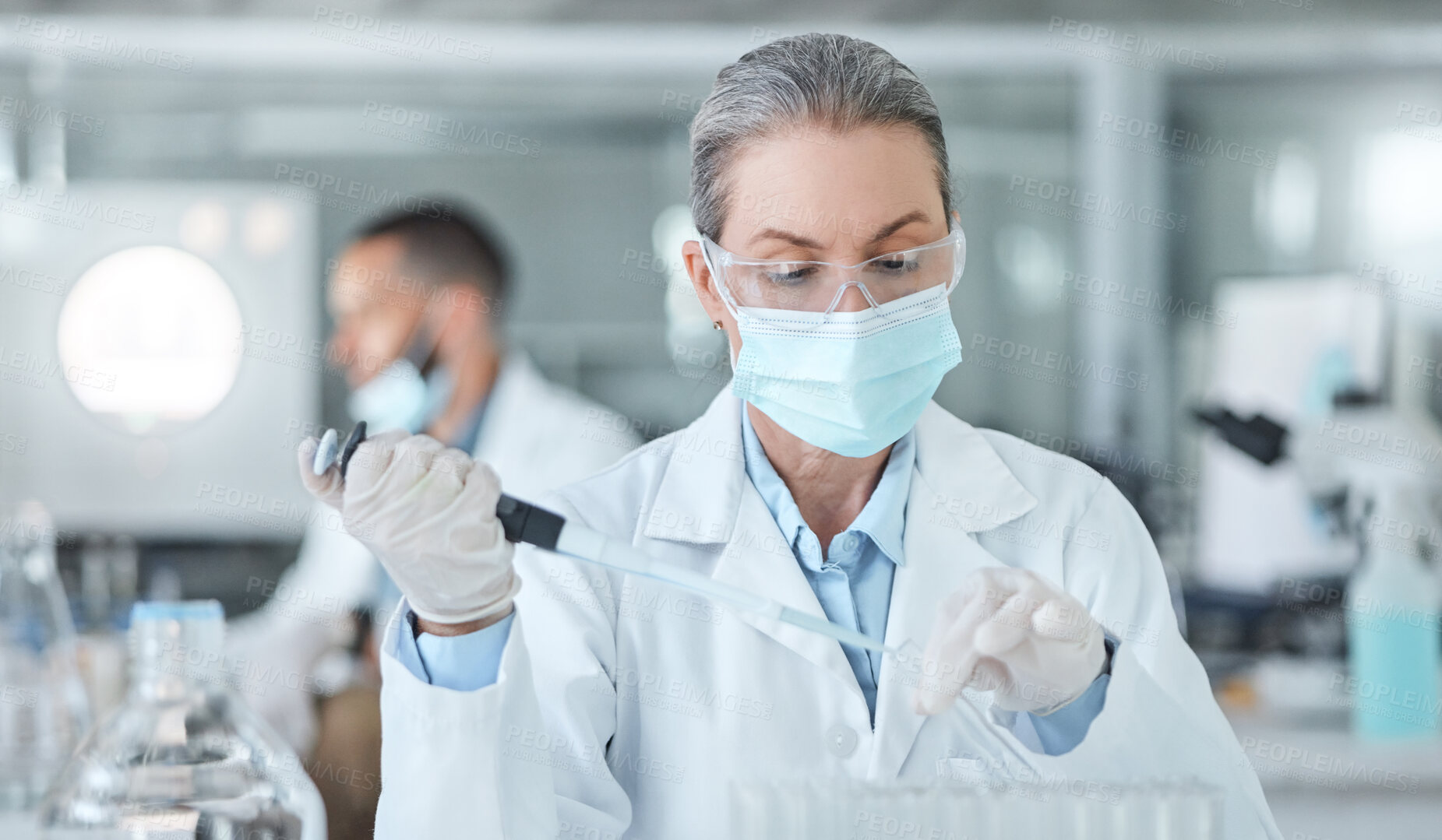 Buy stock photo Covid, lab mask and vaccine research woman with medicine analysis test tube in a lab. Medical development, innovation and professional science expert working on new medical analytics in a laboratory