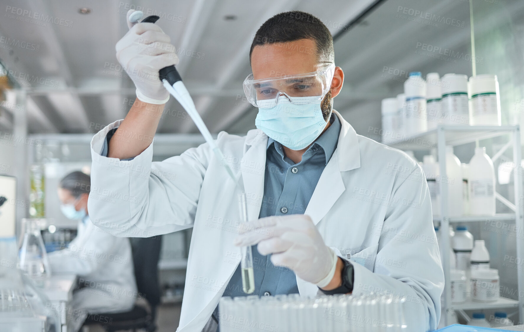 Buy stock photo Covid, scientist man and vaccine research with medicine analysis test tube and chemical pipette in a science lab. Medical development, cure and an expert working on new virus cure in laboratory