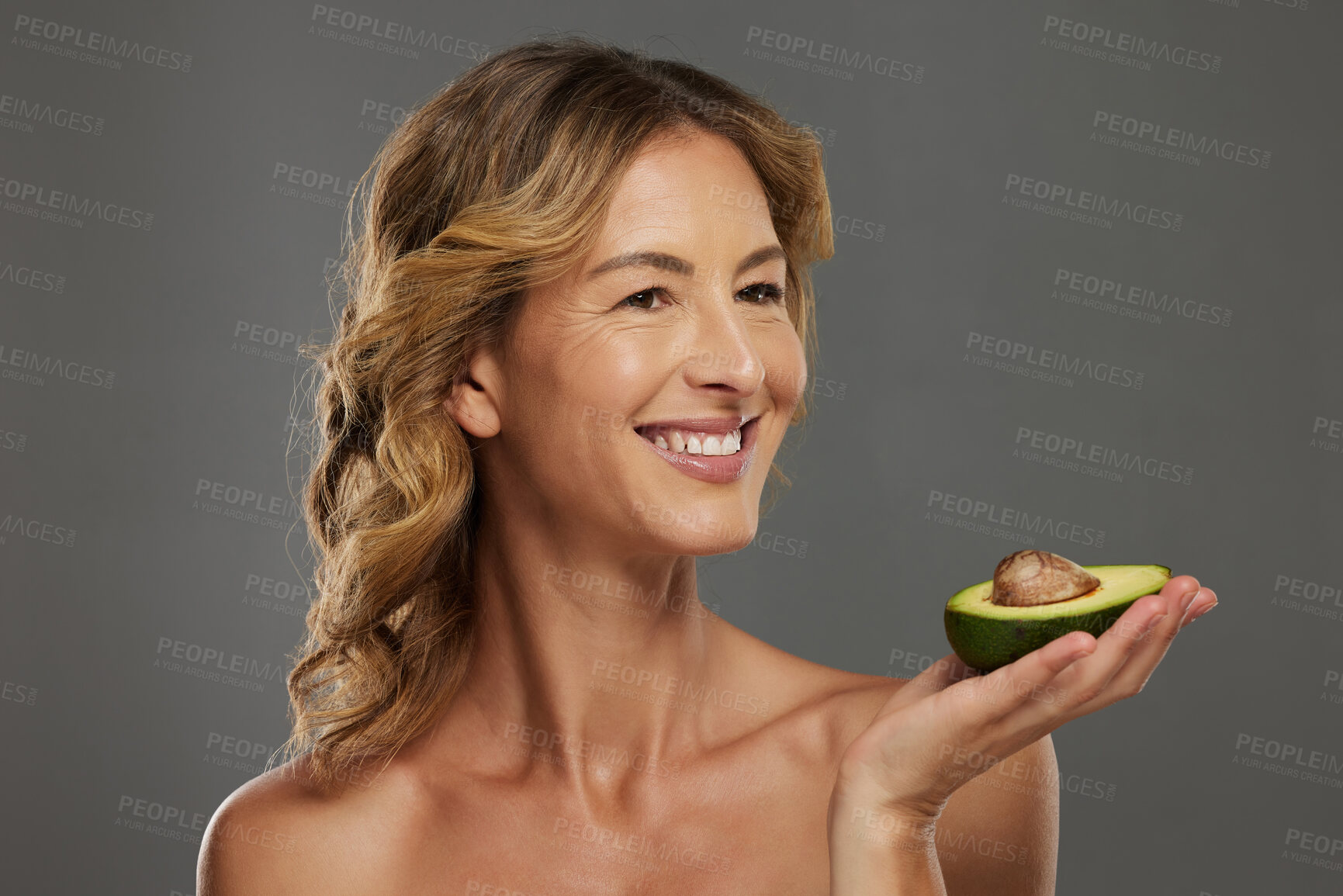 Buy stock photo Woman, happy and avocado in hand for health, wellness and detox care with face. Mature model, dermatology and smile with fruit diet for skincare, hair and beauty with natural facial cosmetic product