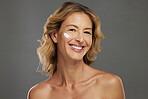 Face of senior woman, skincare cream for beauty and antiaging cosmetic product in Australia on gray background studio. Facial sunscreen in dermatology, portrait of happy person and natural wellness