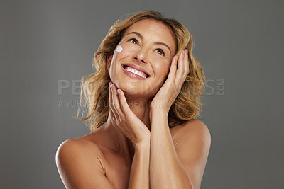 Buy stock photo Face skincare, beauty cream and woman thinking of natural product against a grey mockup studio background. Happy, smile and model with idea for cosmetics, body wellness and cosmetic lifestyle