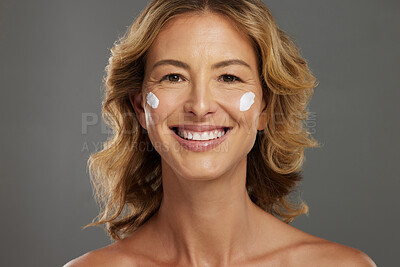 Buy stock photo Face cream, mature skincare and woman with beauty from cosmetics against a grey mockup studio background. Portrait of a happy and healthy model with natural dermatology sunscreen for wellness