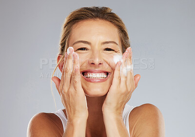 Buy stock photo Skincare, clean and face portrait of a woman washing her skin with beauty treatment in a studio. Happy, smile and healthy mature lady with health, hygiene and self care lifestyle doing facial routine
