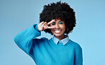 Young, black and woman shows peace sign with blue studio background, trendy style and afro. Smile, happy and relax African American female, lady or girl influencer with casual fashion and cosmetics.