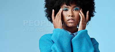 Buy stock photo Blue makeup, fashion and beauty with a black woman in studio against a wall background with mockup. Cosmetics, face and eye shadow with a young female posing for contemporary or edgy style