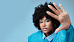 Black woman, hand and mockup with blue makeup against studio background. Model, cosmetics and afro with space on backdrop for marketing, advertising and copy in portrait for fashion, hair or skin