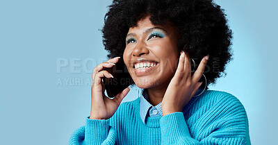 Buy stock photo Black woman, talking on smartphone and smiling on blue background in studio mockup. Stylish african american lady with fashion afro, cellphone conversation and happy talk on 5g communication network 