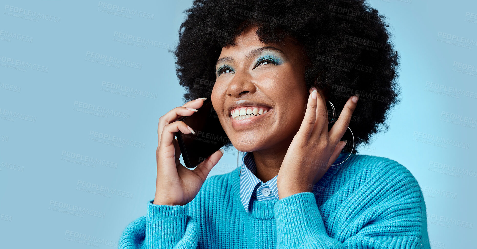 Buy stock photo Black woman, talking on smartphone and smiling on blue background in studio mockup. Stylish african american lady with fashion afro, cellphone conversation and happy talk on 5g communication network 