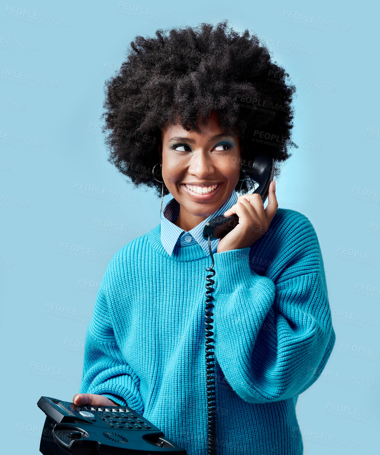 Buy stock photo Landline, communication and black woman talking on a telephone against a blue mockup studio background. Happy, smile and young African model speaking to contact on a vintage phone with mock up space