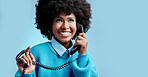 Telecom landline, communication or black woman talking on  telephone on blue mockup studio background. Happy, smile or young African girl model speaking to contact on vintage phone with mock up space