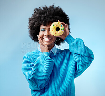 Buy stock photo Black woman, smile and donut with blue makeup against studio background. Model, happy and beauty with cake in hand by face show happiness against fashion backdrop with hair, skin and healthy teeth