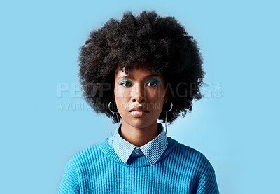 Buy stock photo Black woman afro, portrait and serious face for vision in focus against a blue studio background. African female model in cool fashion with cosmetic eyeshadow makeup on mockup