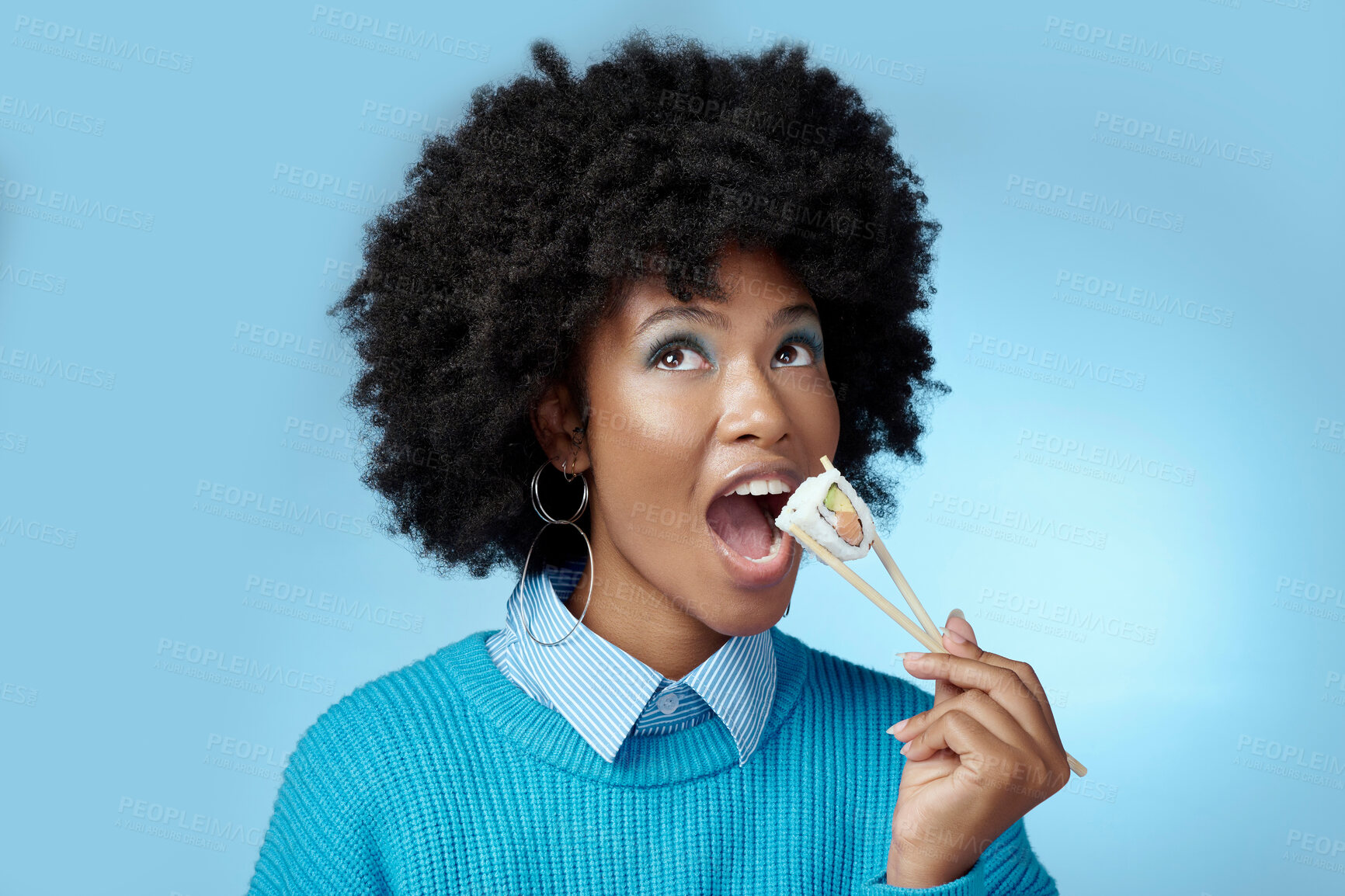 Buy stock photo Sushi, seafood and black woman with smile for seafood from Japan against a blue mockup studio background. African girl eating fish for dinner diet and luxury lunch from restaurant with mock up space