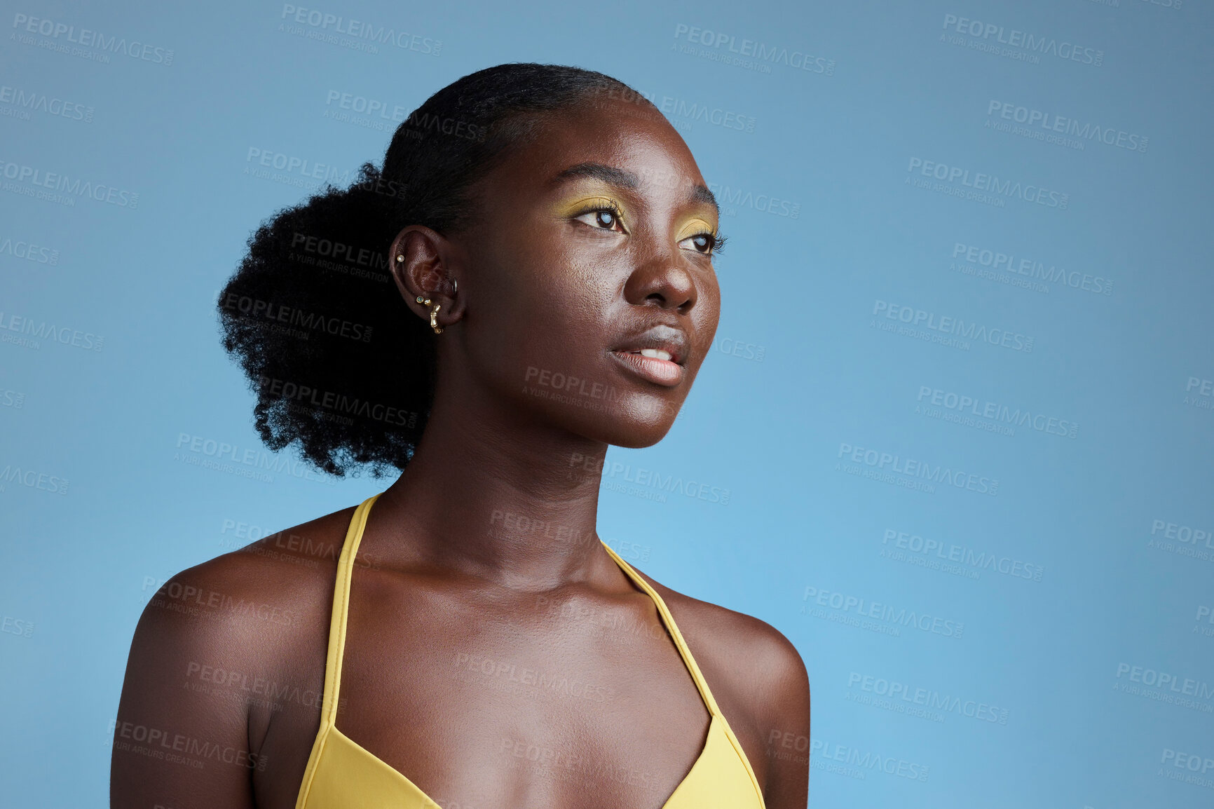 Buy stock photo Black woman beauty and yellow makeup cosmetics model for eye product in blue background studio mockup. Nigeria African young girl pose for natural hair care, healthy skincare and afro empowerment 