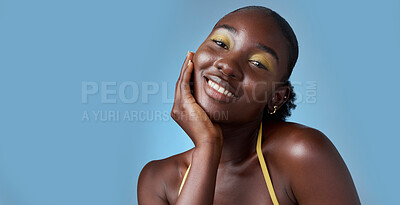 Buy stock photo Black woman, smile and makeup in mockup for skincare beauty and cosmetics against blue backdrop. Model, happy and hand on face, for skin wellness and health in portrait against studio background