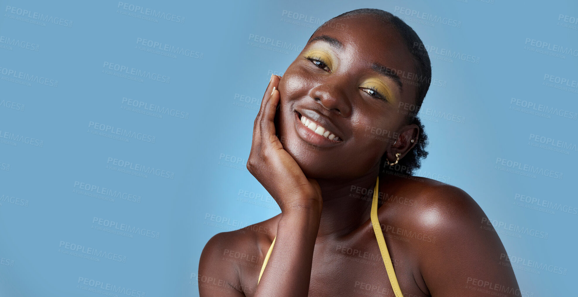 Buy stock photo Black woman, smile and makeup in mockup for skincare beauty and cosmetics against blue backdrop. Model, happy and hand on face, for skin wellness and health in portrait against studio background