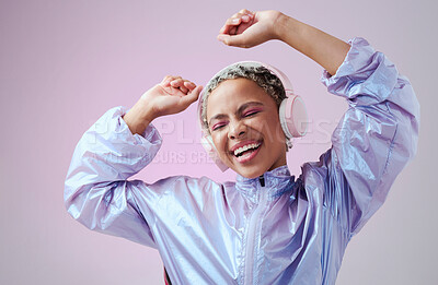 Buy stock photo Dance, fashion woman and headphone listening to music and dancing against purple studio background. African american female smile, audio streaming and enjoy sound with a playful and freedom attitude