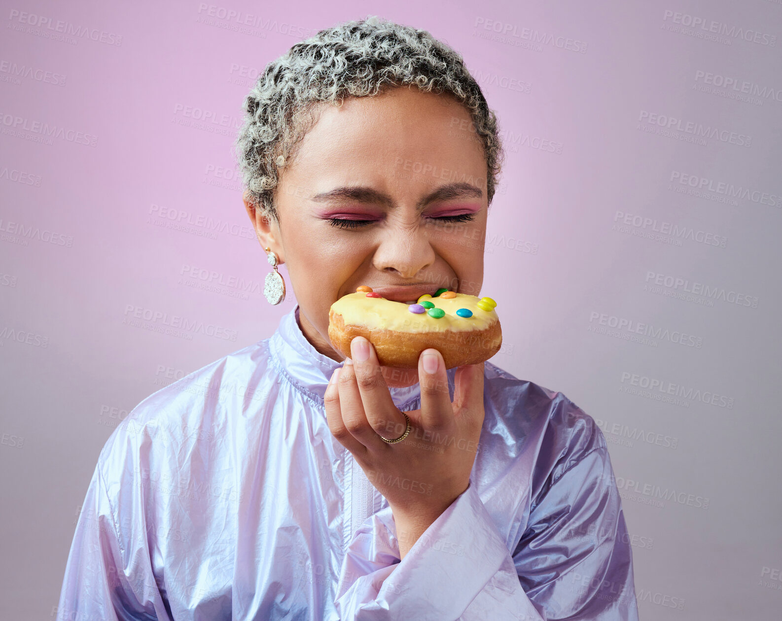 Buy stock photo Food, studio and woman is eating a donut cake with eyes closed enjoying sweet icing and sugar pastry alone. Hungry young girl on a fast food diet with a big bite on a doughnut snack as a cheat meal