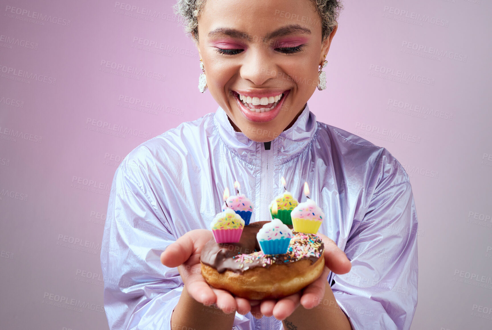 Buy stock photo Happy birthday donut, black woman with cupcake candles and hands holding sweet dessert in New York. Anniversary celebration cake, young cool girl smile in studio with pink background and solo party