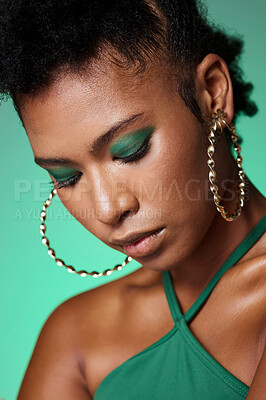 Buy stock photo Beauty, green fashion and makeup with a black woman in studio on a wall background with eye shadow and jewelry. Face, cosmetics and accessories with an attractive young female posing with style 
