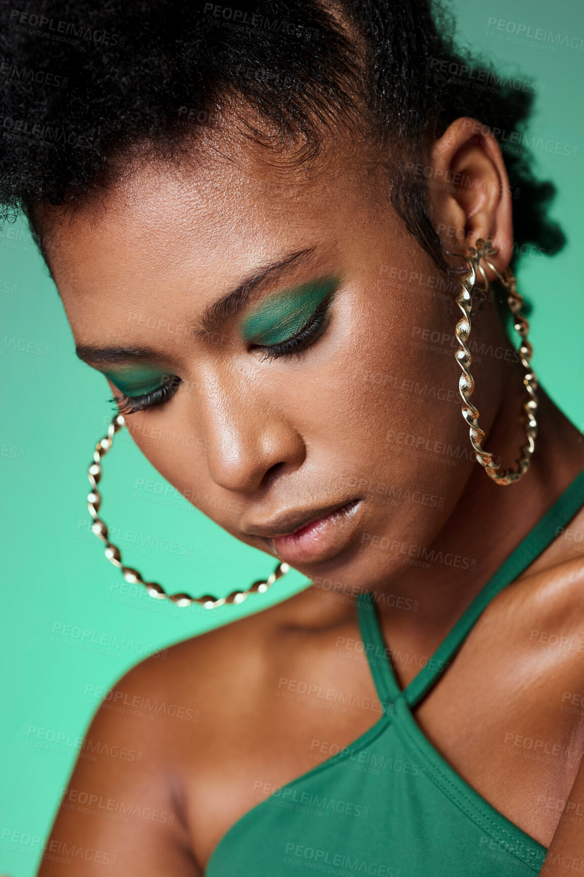 Buy stock photo Beauty, green fashion and makeup with a black woman in studio on a wall background with eye shadow and jewelry. Face, cosmetics and accessories with an attractive young female posing with style 
