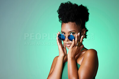 Buy stock photo Portrait of trendy black woman in green background with sunglasses. Mockup for natural beauty, fashion and makeup in spring or summer. Black model in funky glasses, modern style in the studio