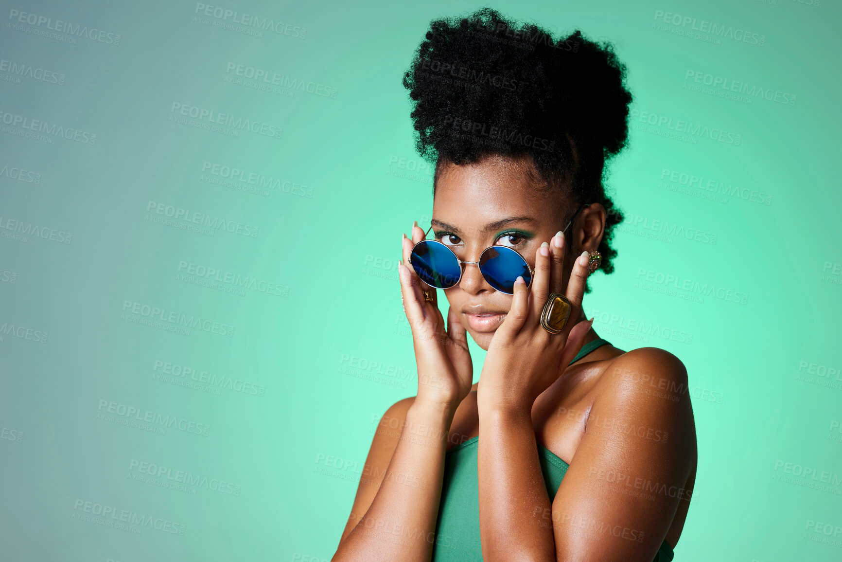 Buy stock photo Portrait of trendy black woman in green background with sunglasses. Mockup for natural beauty, fashion and makeup in spring or summer. Black model in funky glasses, modern style in the studio