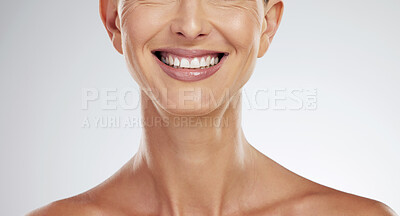 Buy stock photo Teeth, face and mature woman beauty showing her natural looking dental veneers posing on gray studio background. Oral health, healthcare and model woman happy with tooth hygiene dental care closeup.