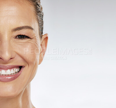 Buy stock photo Half face, skincare and mature woman with smile for facial wellness in retirement against grey mockup studio background. Elderly model with beauty and skin health from dermatology with mock up space