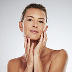 Face, beauty and skincare with woman hands touching her skin in a studio on a gray background. Product, antiaging and cosmetics with a mature female posing for health, wellness or natural care