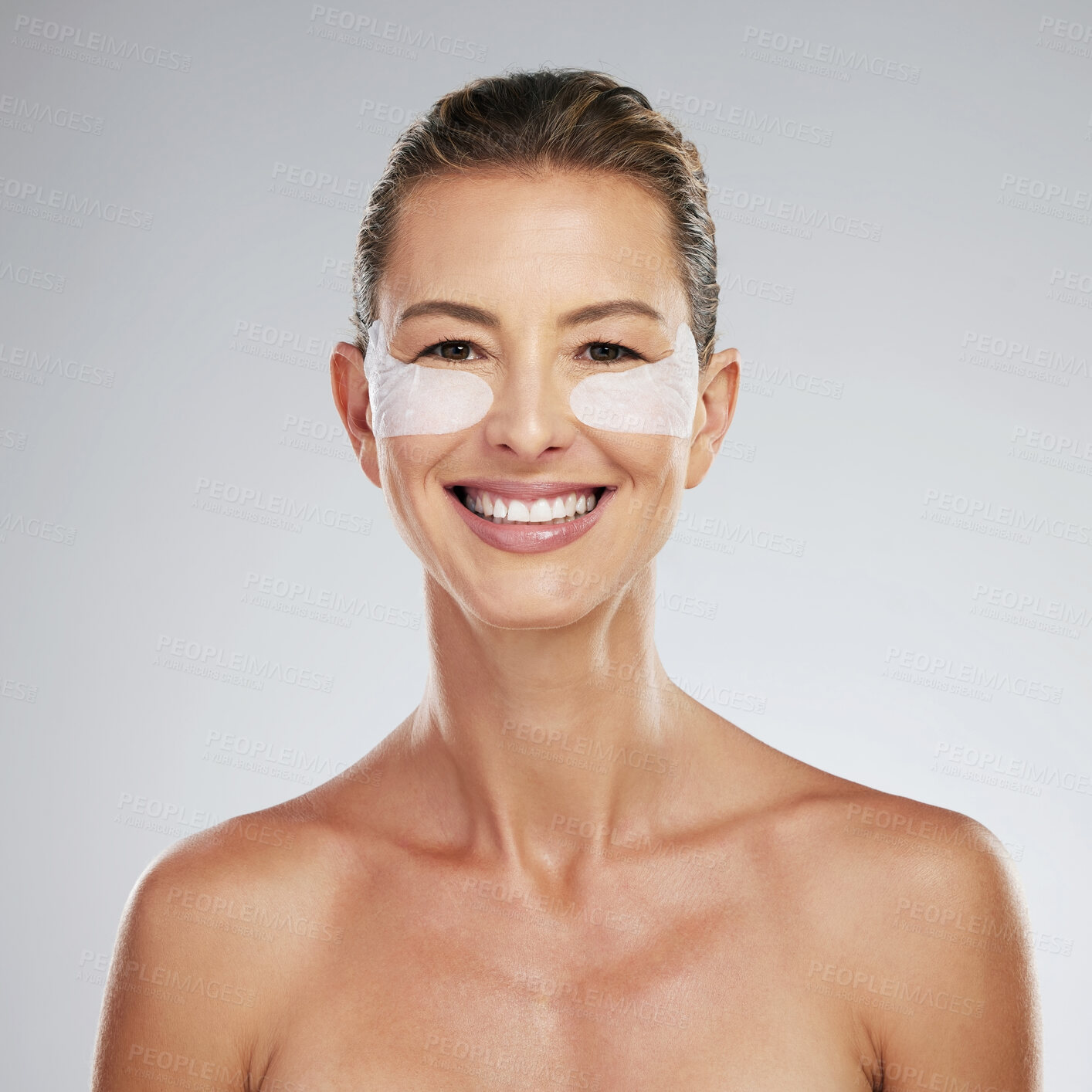 Buy stock photo Eye wellness, skincare and mature woman at beauty dermatology spa against a grey mockup studio background. Portrait of an elderly model with smile and happy about luxury gel patches for eyes