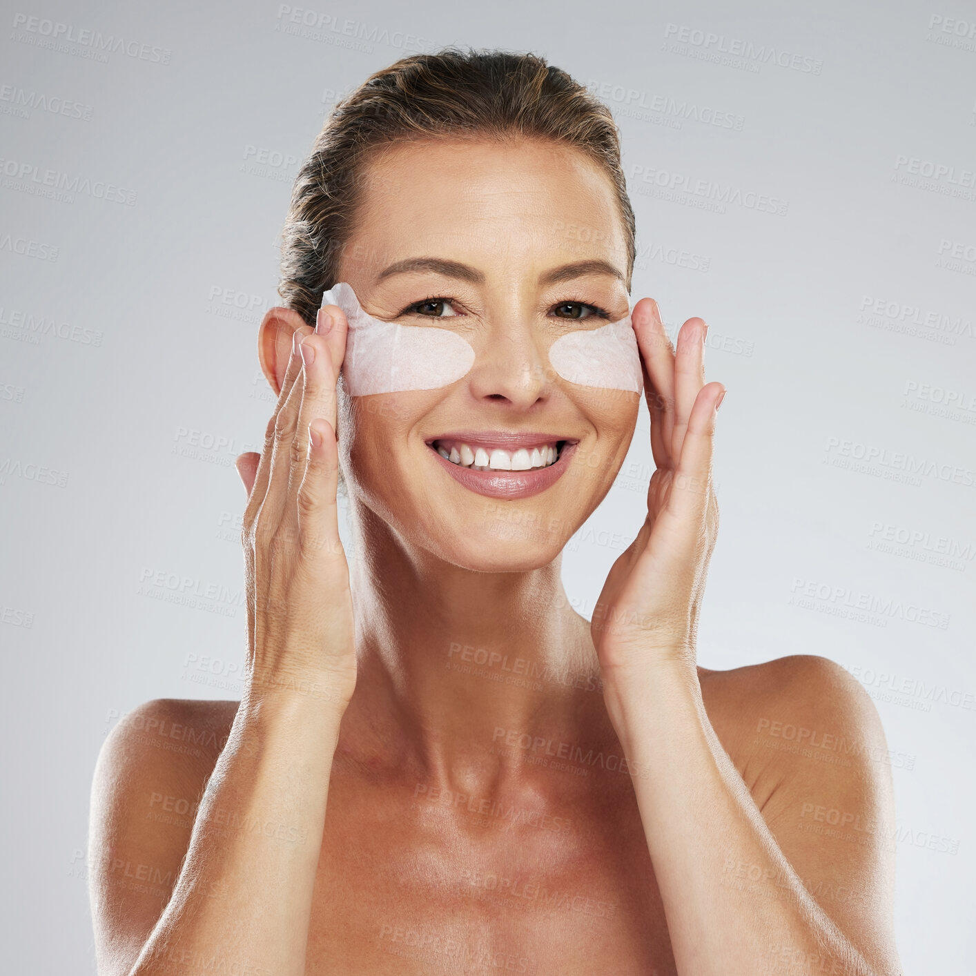 Buy stock photo Skincare, mature woman and eye patches on a studio gray background. Portrait, beauty and happy model touching facial collagen pads, face or makeup cosmetics for skin anti aging, wellness or hydration