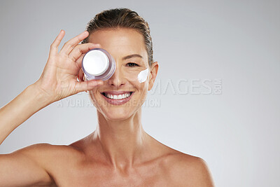 Buy stock photo Cream, eye skincare and mature woman with natural wellness beauty product against grey mockup studio background. Portrait of elderly model with jar of facial dermatology lotion and mock up space