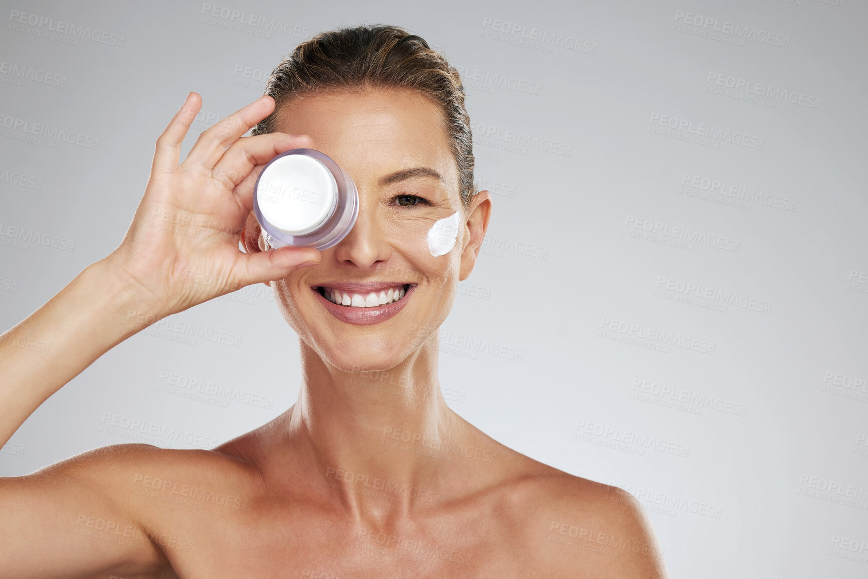 Buy stock photo Cream, eye skincare and mature woman with natural wellness beauty product against grey mockup studio background. Portrait of elderly model with jar of facial dermatology lotion and mock up space