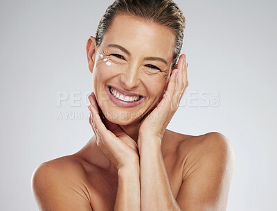 Buy stock photo Model, cream and skincare with hands on mature face in beauty, wellness and happiness with smile in portrait. Woman, skin and happy for dermatology, cosmetic and health against studio background