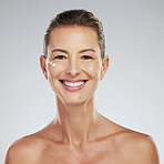 Skin, skincare and beauty portrait of mature woman with anti aging cream on her face. Mockup for dermatology, wrinkles and facial care for youth. Happy smiling middle aged girl with natural beauty