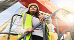 Engineer, black woman and logistics manager showing leadership wearing safety vest and hardhat on tractor at shipping yard or construction site. Female working as an inspector or foreman in Africa