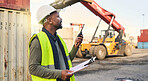 Black man engineer, checklist and container manager  planning distribution, shipping and delivery logistics. African supply chain stock and cargo worker on walkie talkie for freight industry business