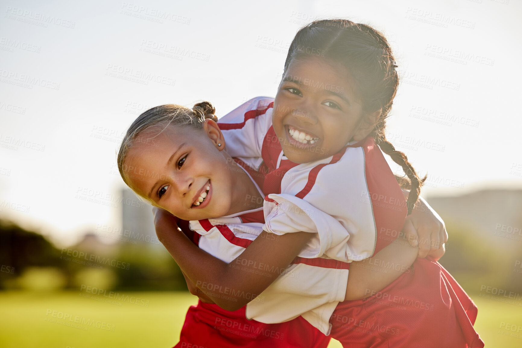 Buy stock photo Girl football players, children hug and smile after sports training match for competition. Young football friends, embrace after game and learning collaboration and teamwork together while exercising