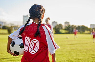 Buy stock photo Children, sport and football with a girl soccer player on a field outdoor for fitness, exercise or training. Sports, workout and kids with a female child on grass for health, wellness and recreation
