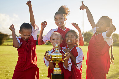 Buy stock photo Children, football trophy and winning team of sports competition on soccer field for celebration of goal, win and teamwork after a match outdoors. Youth, kids or girls club after a tournament game