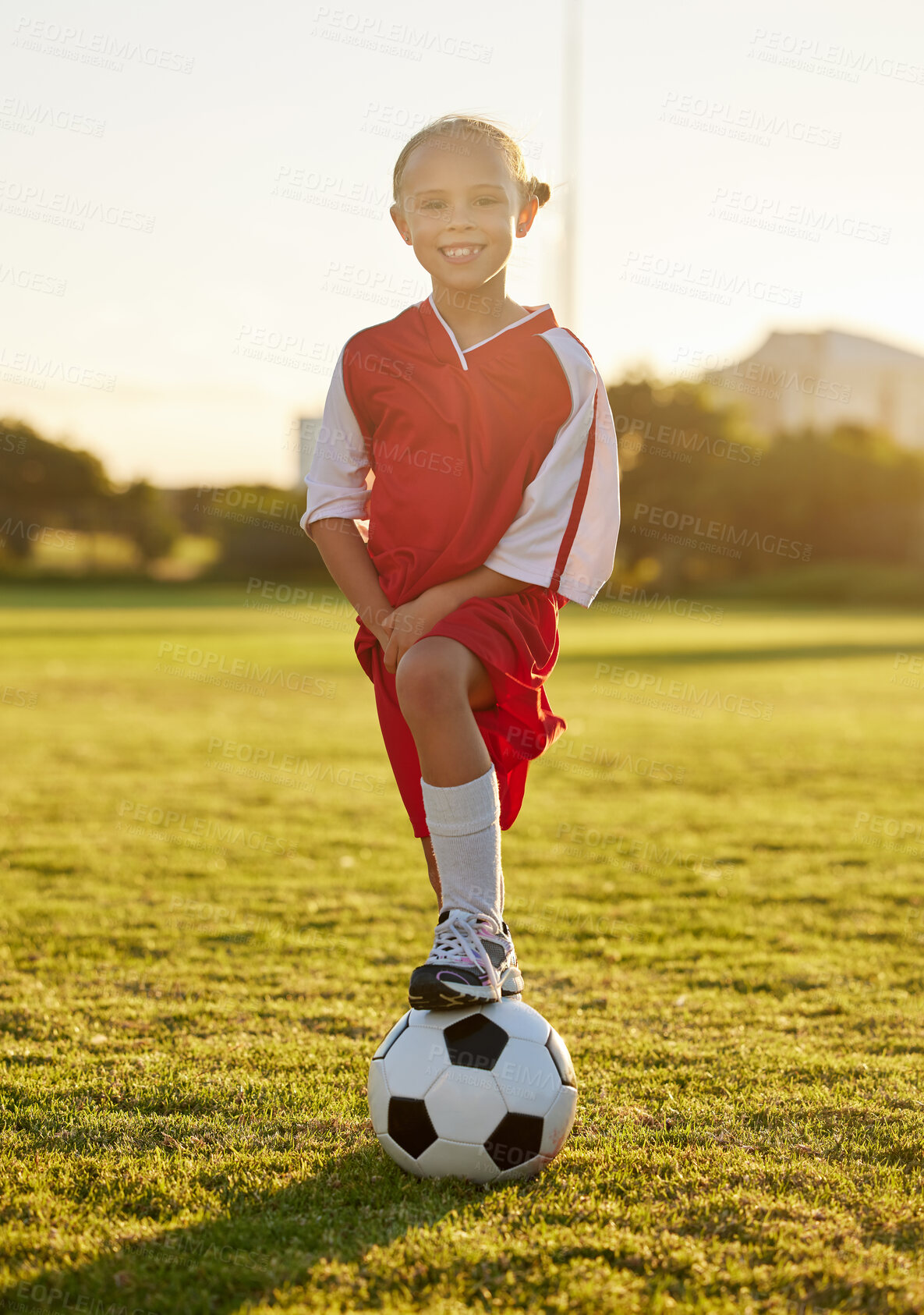 Buy stock photo Football or soccer athlete, girl or player learning, training and exercise for healthy child development. Portrait of young happy sports kid on a field or stadium practicing for a game at sunset