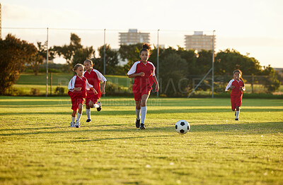 Buy stock photo Sports, fitness and soccer training by girl team playing on grass field, teamwork during football game. Health, exercise and children learning to play in competitive match with energy and soccer ball